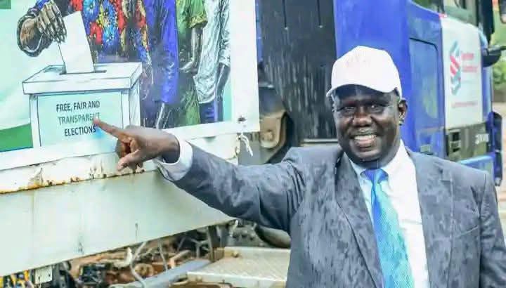 Gabriel Bol Deng Majok beside election-related material