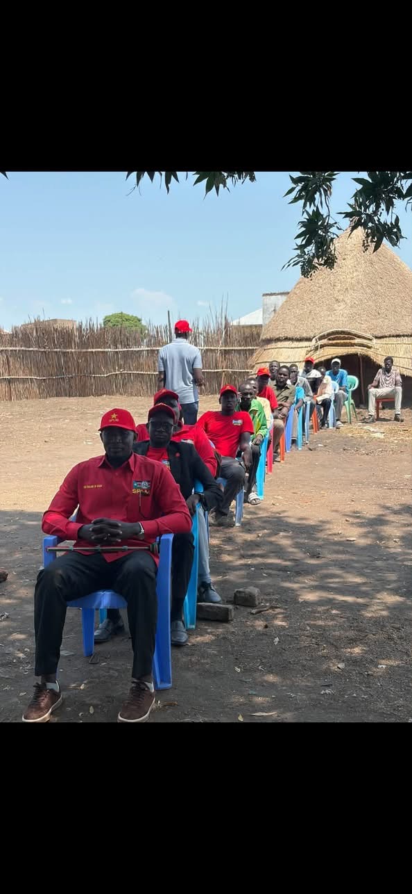 Supplied image showing people seated in a line outdoors
