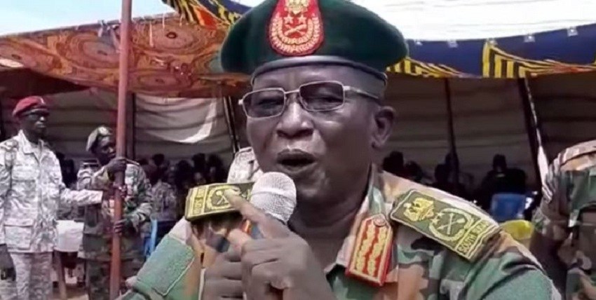 Military officer in South Sudan uniform speaking into a microphone